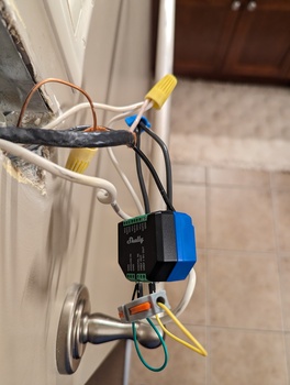 Wires from the wall connect to a small blue and black box.